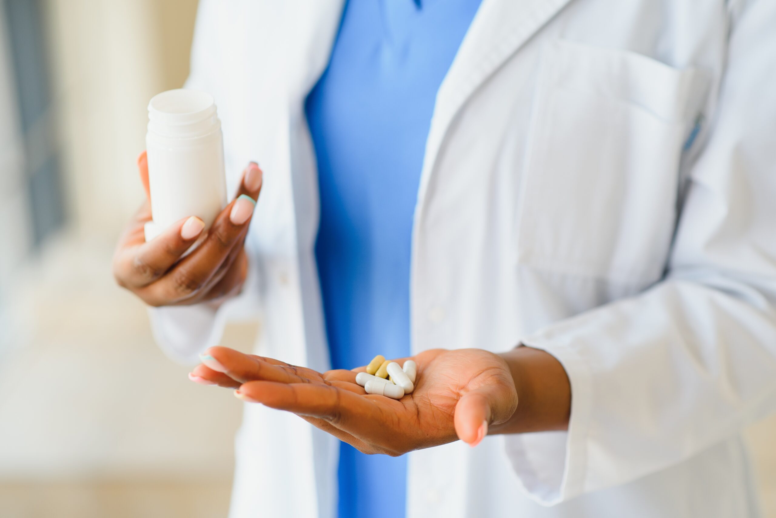 Woman holding out pills