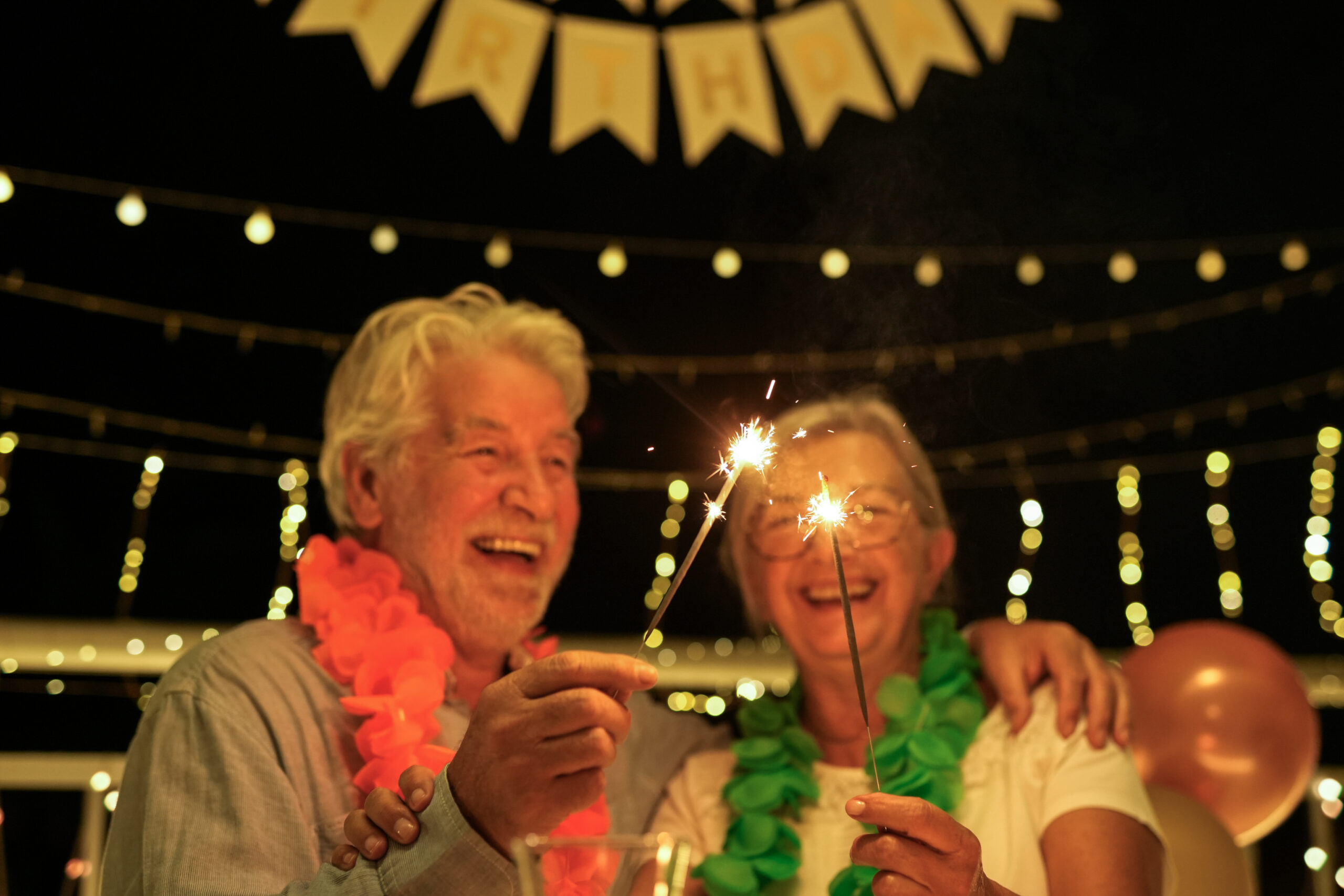Happy family senior couple celebrating birthday at night party s